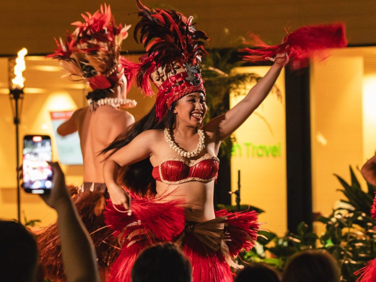 a group of people in a room with a christmas tree